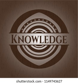 Knowledge badge with wooden background