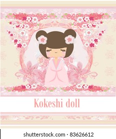 Kokeshi doll on the pink background with floral ornament