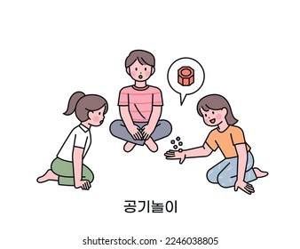 Korean childhood games. The children are sitting together and playing jackstone. play with small stones Korean translation five stones game