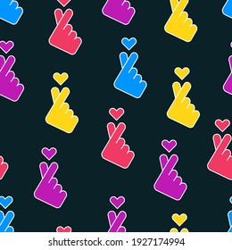 Korean love sign. Finger heart gesture. Sarangae icon. Seamless pattern on black background.