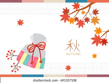 Korean traditional lucky bag with maple leaves background.Translation: Autumn