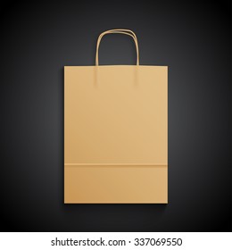 Kraft paper bag with handles on black background. Mock up