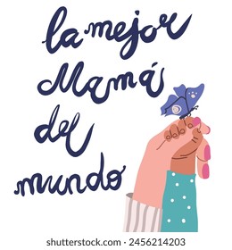 La mejor mama del mundo, Best Mom in the World in Spanish handwritten typography, hand lettering. Mother's Day card.  Child's hand and adult hand interact. 