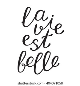 La vie est bell, life is beautiful in French. Brush hand lettering. Brush calligraphy. Handwritten word in French.