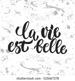 la vie est belle - hand drawn French lettering phrase (it means Life is beautiful) isolated on the white grunge background. Fun brush ink inscription for greeting card or t-shirt print, poster design