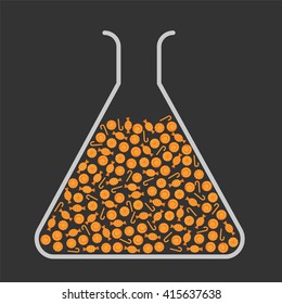 Lab flask filled with orange candies
