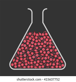 Lab flask filled with red candies
