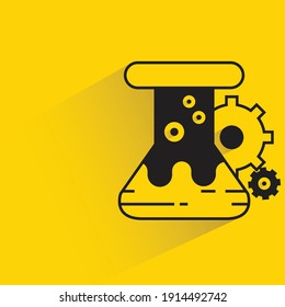 lab flask and gear with drop shadow yellow background