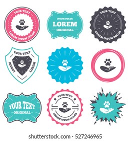 Label and badge templates. Shelter pets sign icon. Hand holds paw symbol. Animal protection. Retro style banners, emblems. Vector
