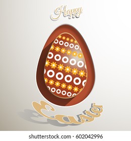 Label of brown Easter egg with floral pattern and text on the light gray background.