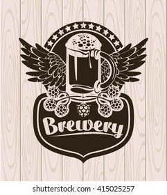 label with a glass of beer and wings on the background of the wooden planks and labeled Brewery