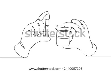 The laboratory assistant's hands hold a test tube with blood and a container with urine. Study of human biological materials in the laboratory. Medical analysis.