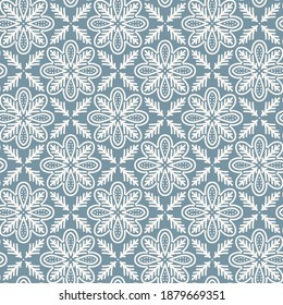 lace floral shaped elements in regular rows monochrome vector tile seamless pattern on blue background