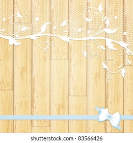 lace frame with blue bow at light wooden background
