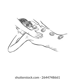 A lady being massaged with hot stones