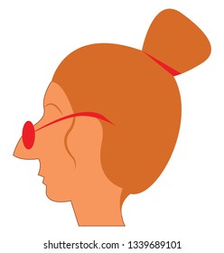 A lady with long pointed nose with her spectacles resting on it and hair tied up in a high bun 