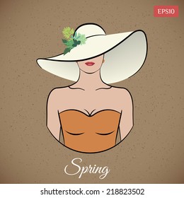 Lady spring in wide-brimmed hat with leaves