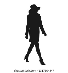 Lady walking in hat and coat, isolated vector silhouette, side view