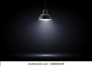 Lamp in dark room. Spotlight on black background. Place for text or product presentation.