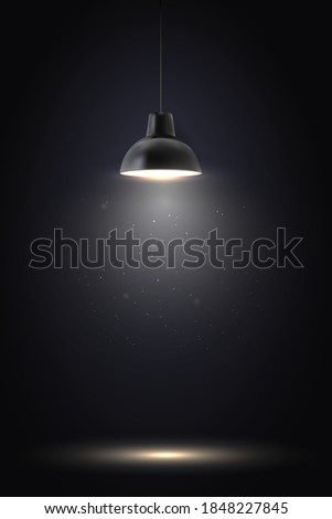 Lamp in dark room. Spotlight on black background. Place for text or product presentation.