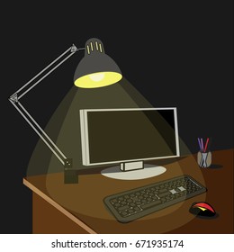Lamp illuminated desktop with computer at night