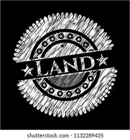 Land written on a chalkboard