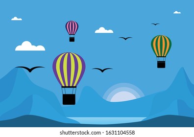 Landscape with a balloon, mountains and sunset