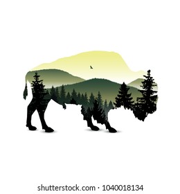 Landscape. Silhouette of buffalo with panorama of mountains. A fog. Green and yellow tones.