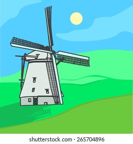Landscape with windmill in a green field, blue sky. 