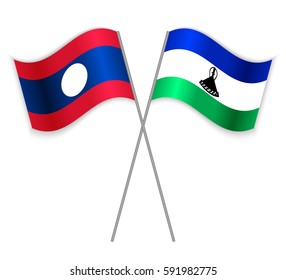 Laotian and Basotho crossed flags. Laos combined with Lesotho isolated on white. Language learning, international business or travel concept.