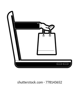 laptop computer and hand holding shopping bag of purchase online in black silhouette