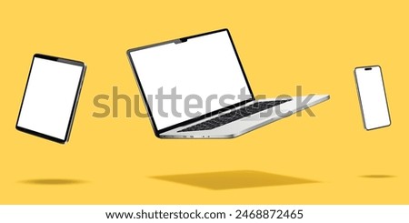 Laptop computer, smartphone and tablet while levitating in the air on a yellow background