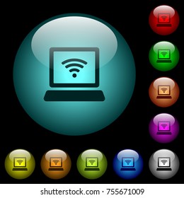 Laptop computer with wireless symbol icons in color illuminated spherical glass buttons on black background. Can be used to black or dark templates