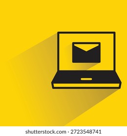 laptop with email icon shadow on yellow background