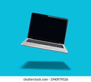 Laptop floating on blue background