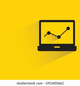 laptop and graph for data analytics with shadow on yellow background