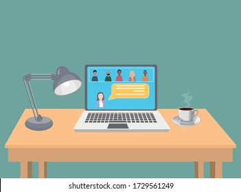 Laptop with a group of people in video conference . Meeting for work job or social meeting. Laptop over a wood table with a lamp and a cup of coffee.
