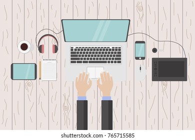 laptop and hands and gadgets on the table top