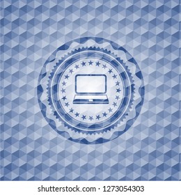 laptop icon inside blue hexagon badge.