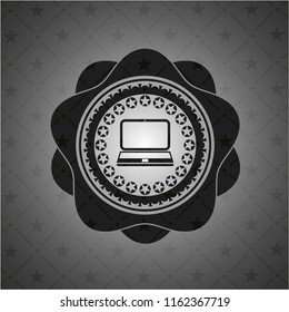 laptop icon inside dark badge or emblem