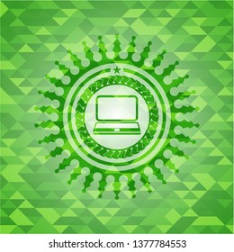 laptop icon inside green emblem with triangle mosaic background