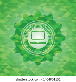 laptop icon inside green emblem with mosaic background