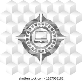 laptop icon inside grey badge with geometric cube white background