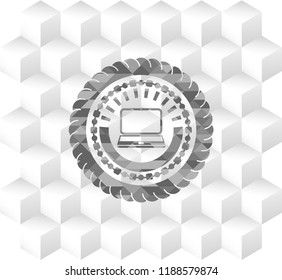 laptop icon inside grey emblem with geometric cube white background