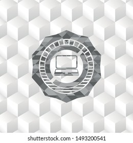 laptop icon inside grey emblem with geometric cube white background