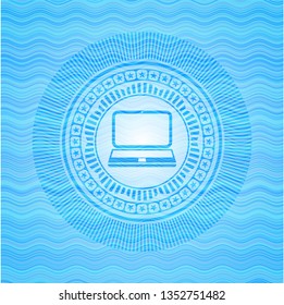 laptop icon inside light blue water wave badge background.