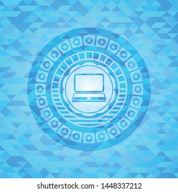 laptop icon inside light blue emblem with mosaic background