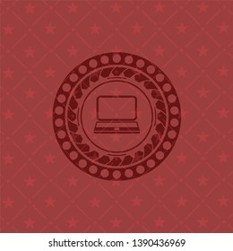 laptop icon inside red emblem