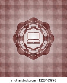 laptop icon inside red seamless emblem with geometric background.