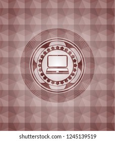 laptop icon inside red seamless geometric emblem.